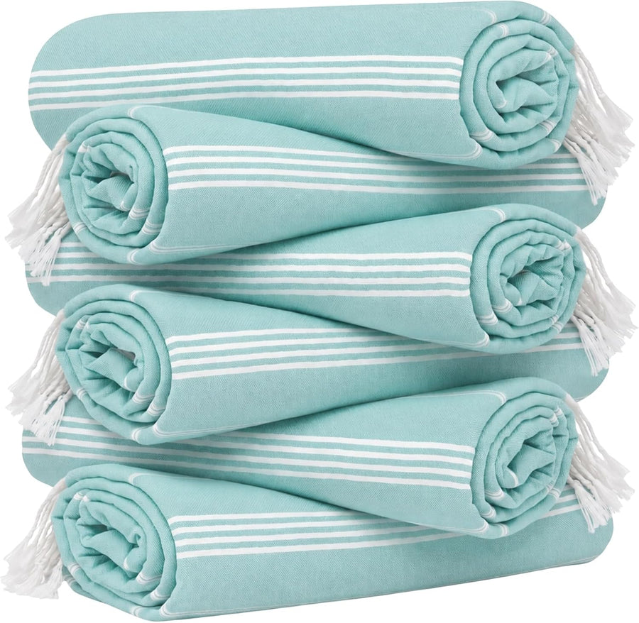 Six rolled Turkish towels stacked in a pyramid arrangement, each in aqua with white stripes and white fringe tassels at the ends. Two rows of three towels each, shown against a white background.