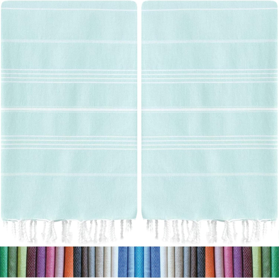 Two matching mint\/aqua Turkish towels with white horizontal stripes and white knotted fringe at the bottom edge, shown side by side. A color swatch strip below displays the many available color options.